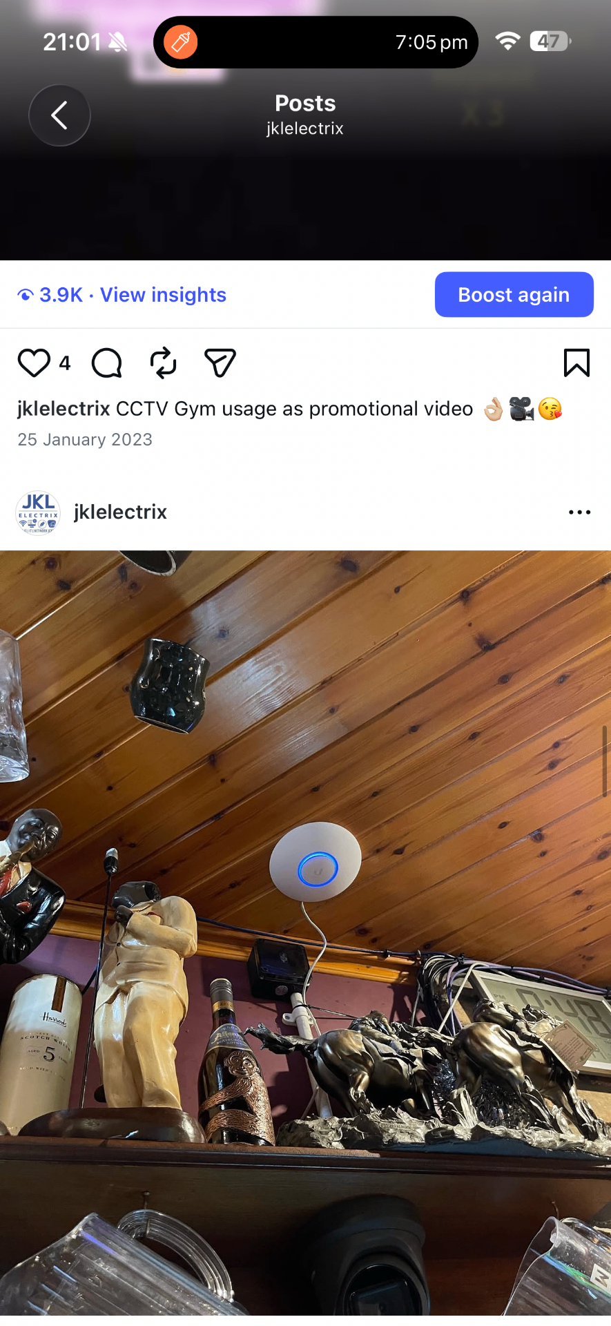 Enterprise access point installed alongside CCTV coverage in a bar interior at Mulholland's