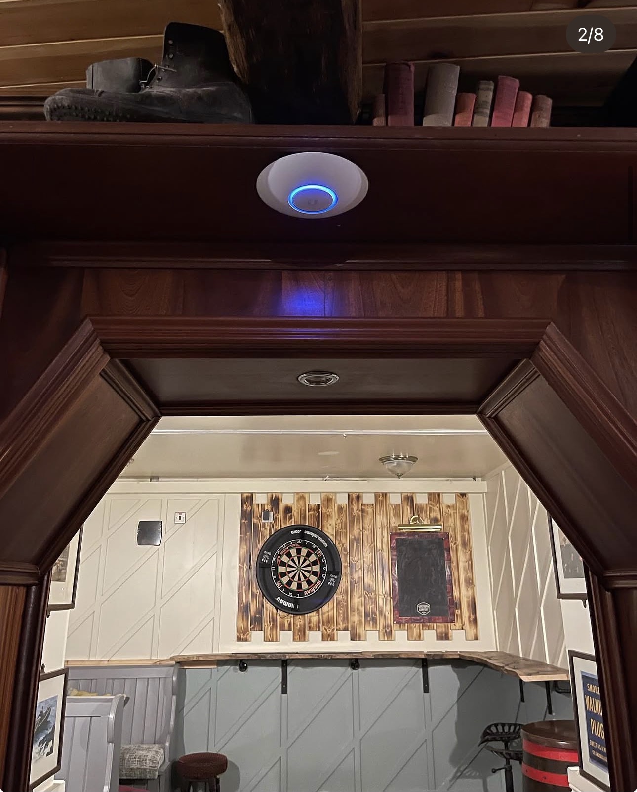 Enterprise Ubiquiti UniFi access point installed above an internal archway in Mulholland's Bar, Castlewellan