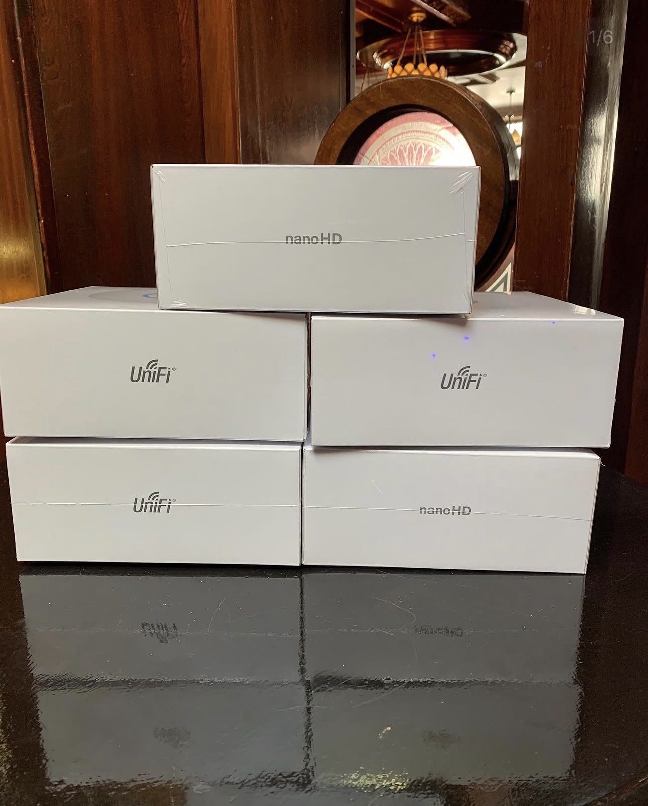 Stack of Ubiquiti UniFi nanoHD enterprise access points ready for install at Quinn's Bar