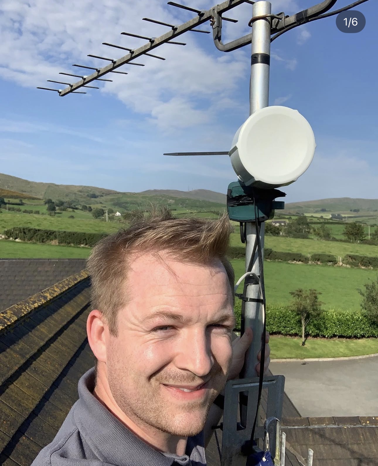 Jon at a rural installation with a wireless point-to-point dish and TV aerial in the Mourne countryside