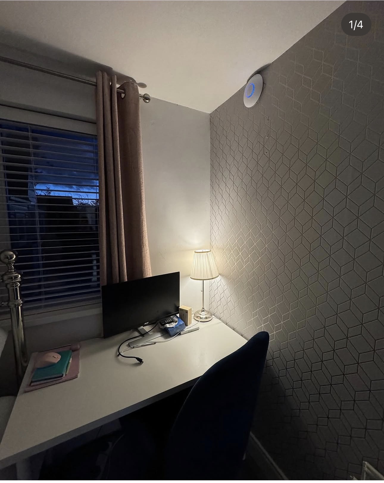 Entry-level UniFi access point neatly wall-mounted above a home office desk in Crossgar