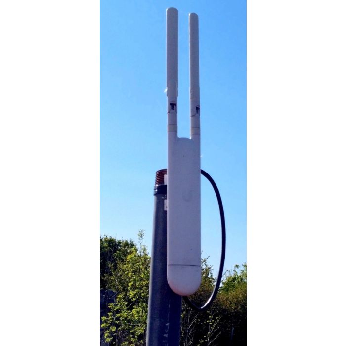Ubiquiti UniFi outdoor access point installed on the exterior of a building