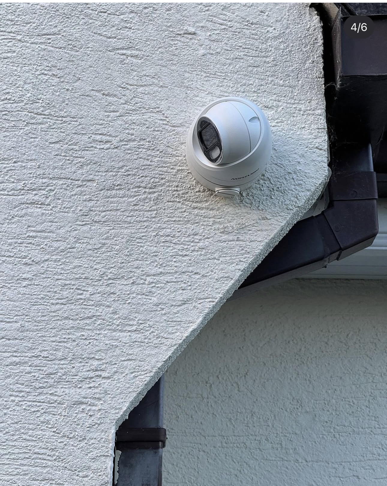 Hikvision dome CCTV camera installed under the eaves of a Newcastle home with no visible cabling