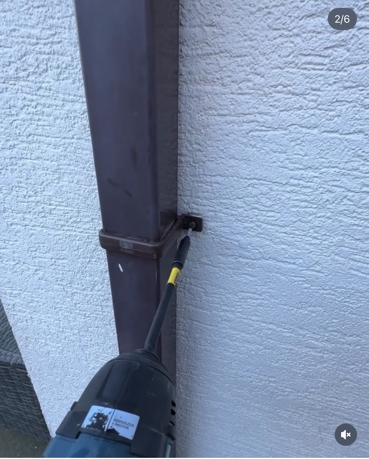 CCTV cable concealed inside an existing external downpipe so no cabling is visible on the wall